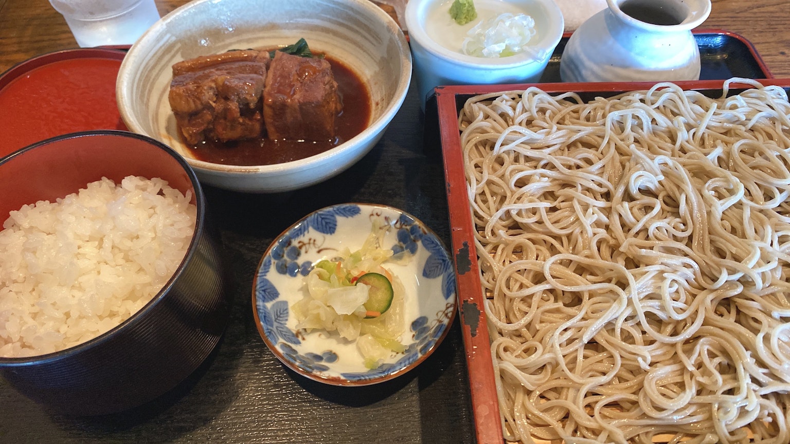 Soba noodles with rice and braised dish in traditional Japanese presentation