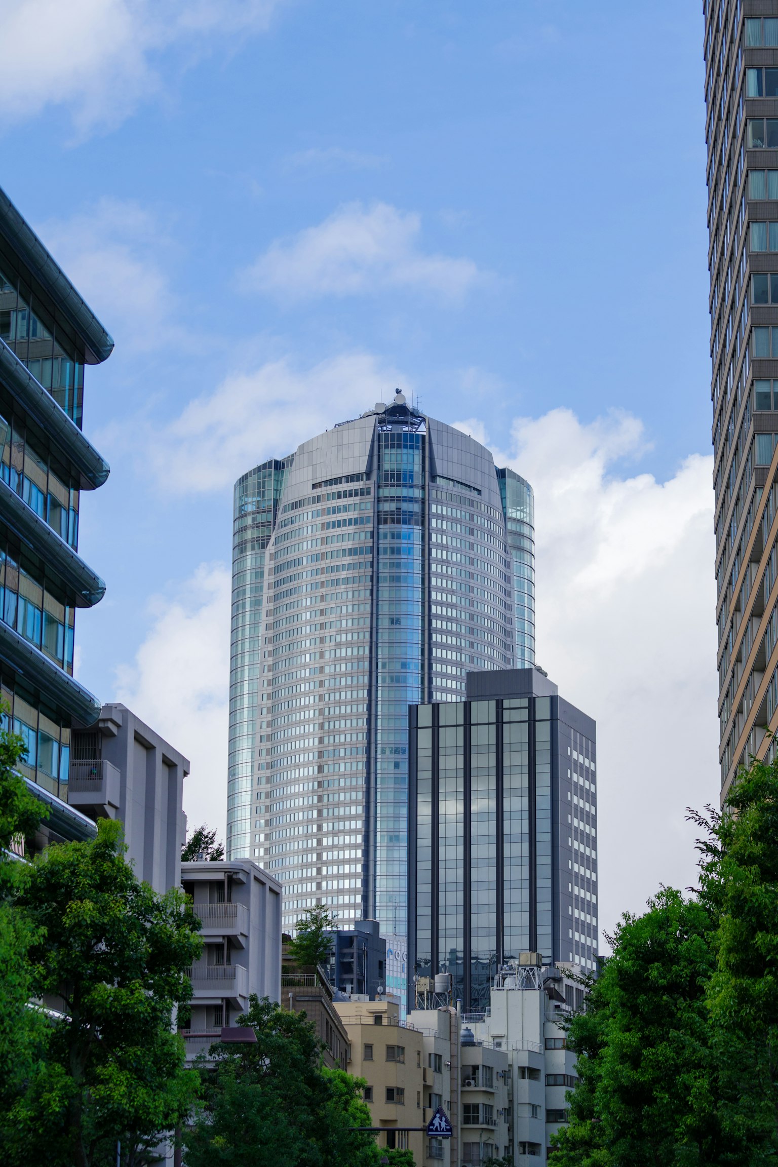 Skyscraper towering under a blue sky in an urban landscape