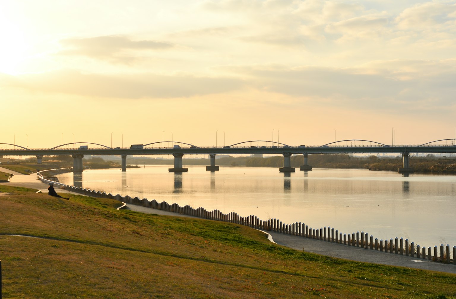 Scenic view of a river and bridge at sunset