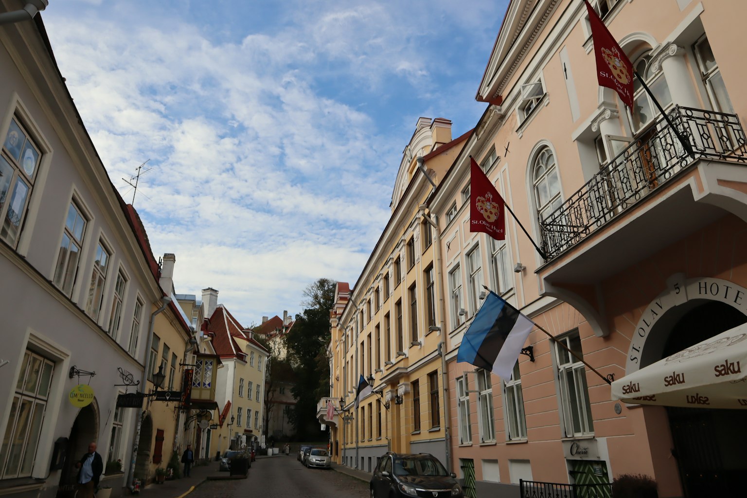 View of a historic street in Tallinn with the Estonian flag displayed