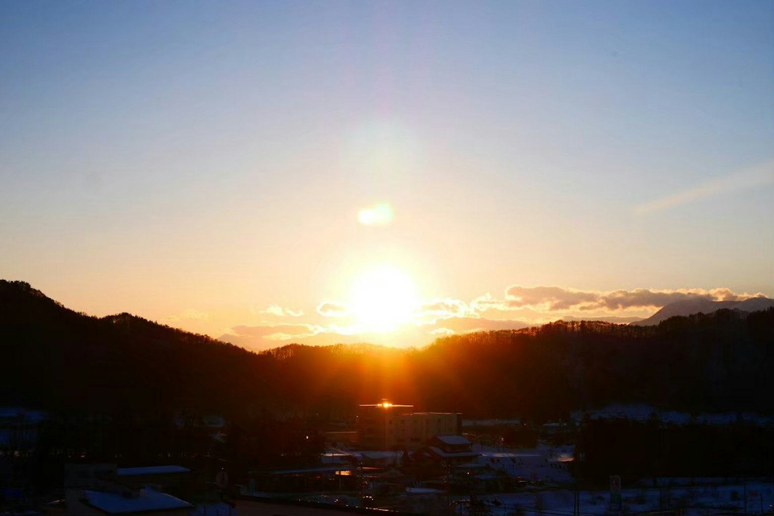 Beautiful landscape with the sun rising between mountains