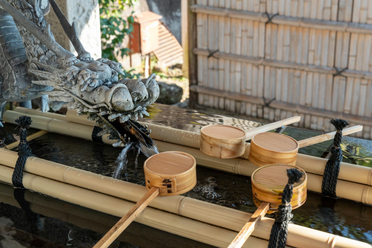 Bamboo water basin with dragon sculpture and wooden ladles