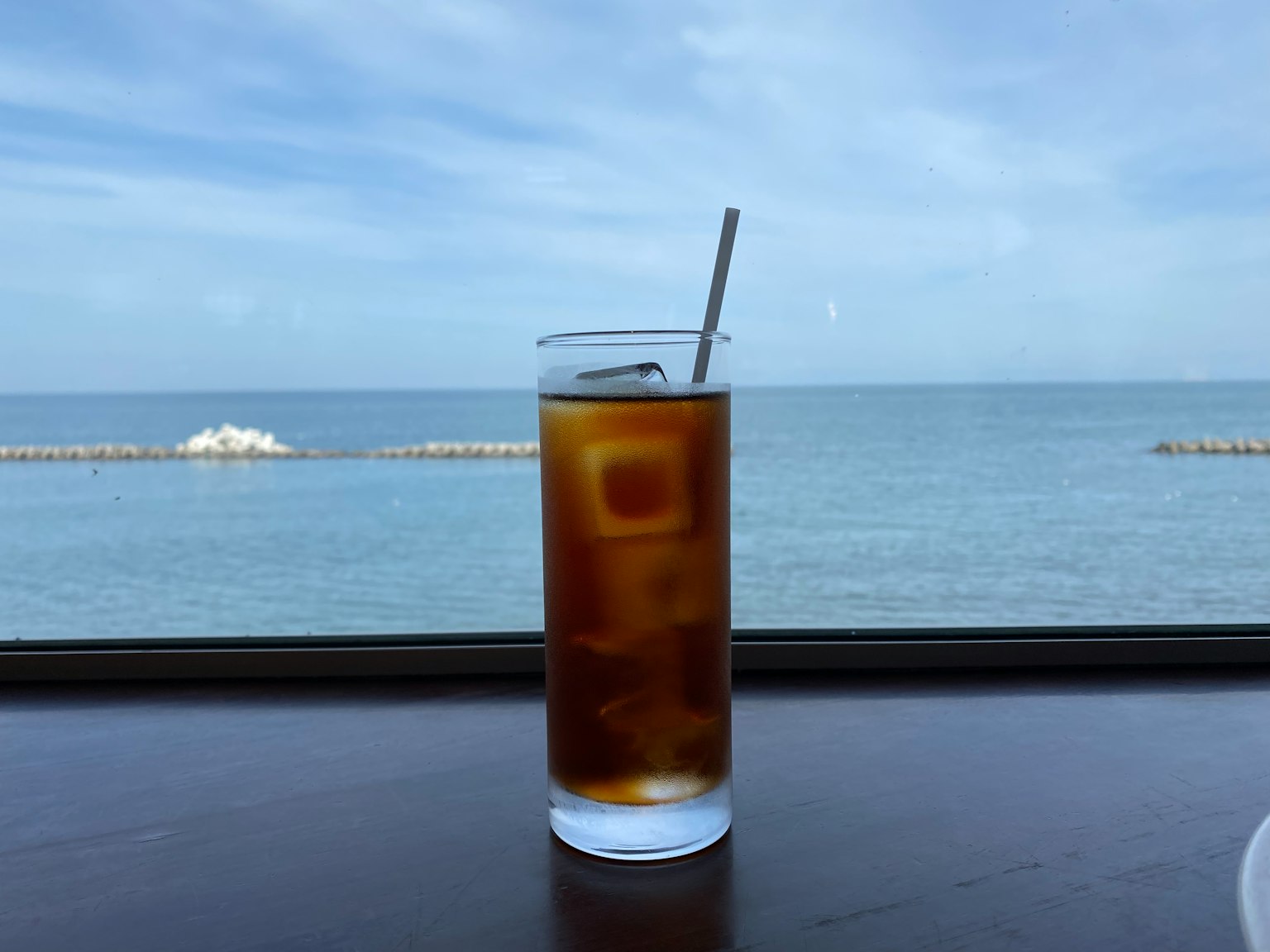 Glass of iced tea with ocean view