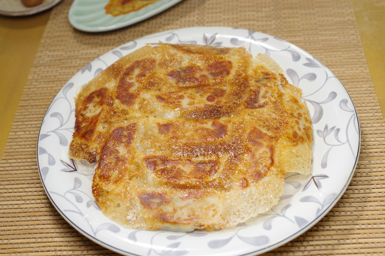 Crispy flatbread with a golden brown surface on a round plate