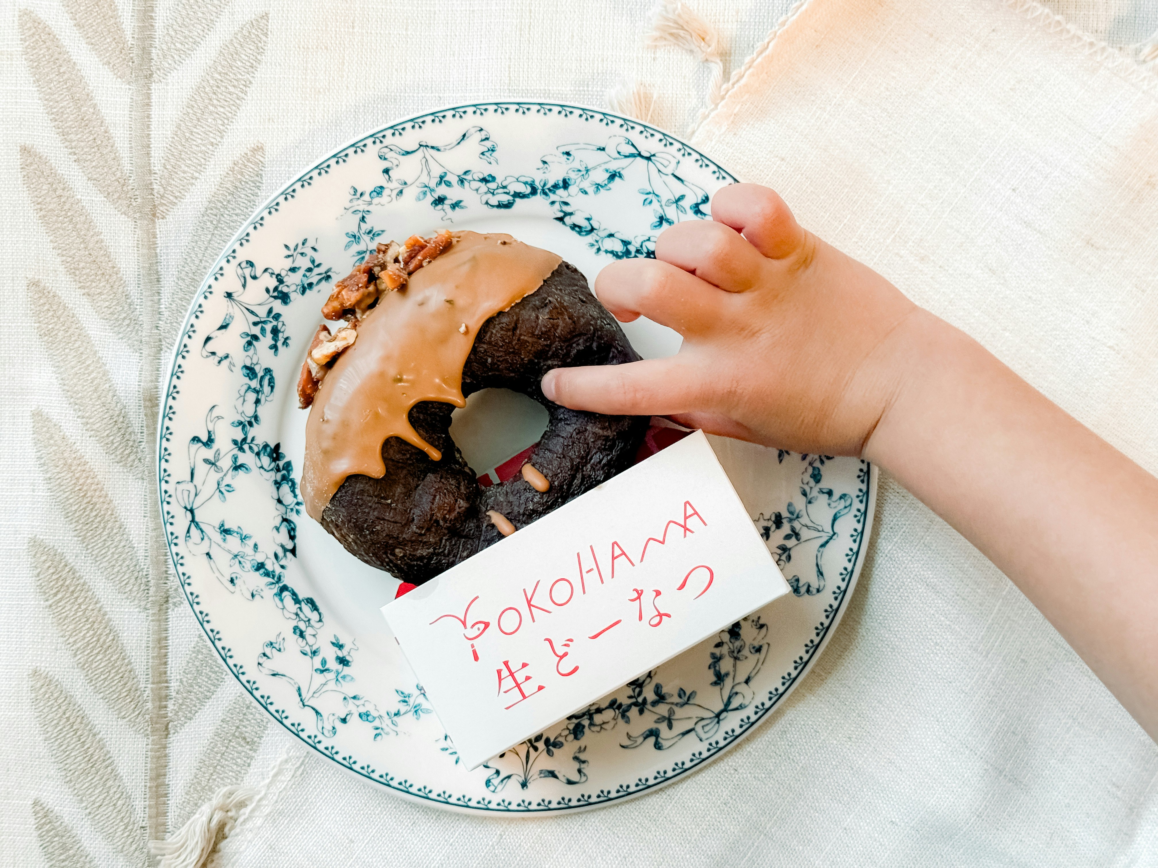hand breaking a Japanese-style baked sweet on a plate