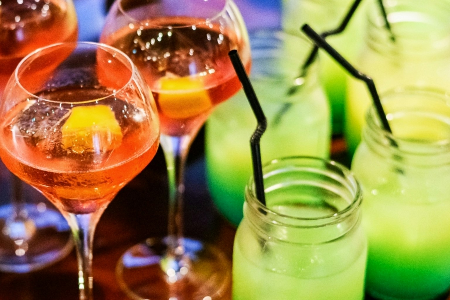 Imagen de cócteles y bebidas coloridas dispuestas sobre una mesa