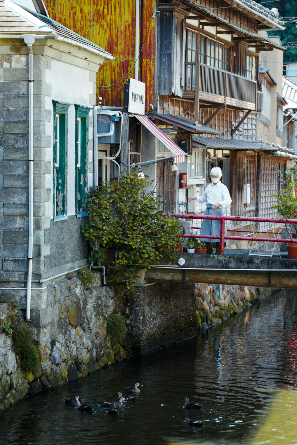 Stone-lined canal alley with wooden buildings