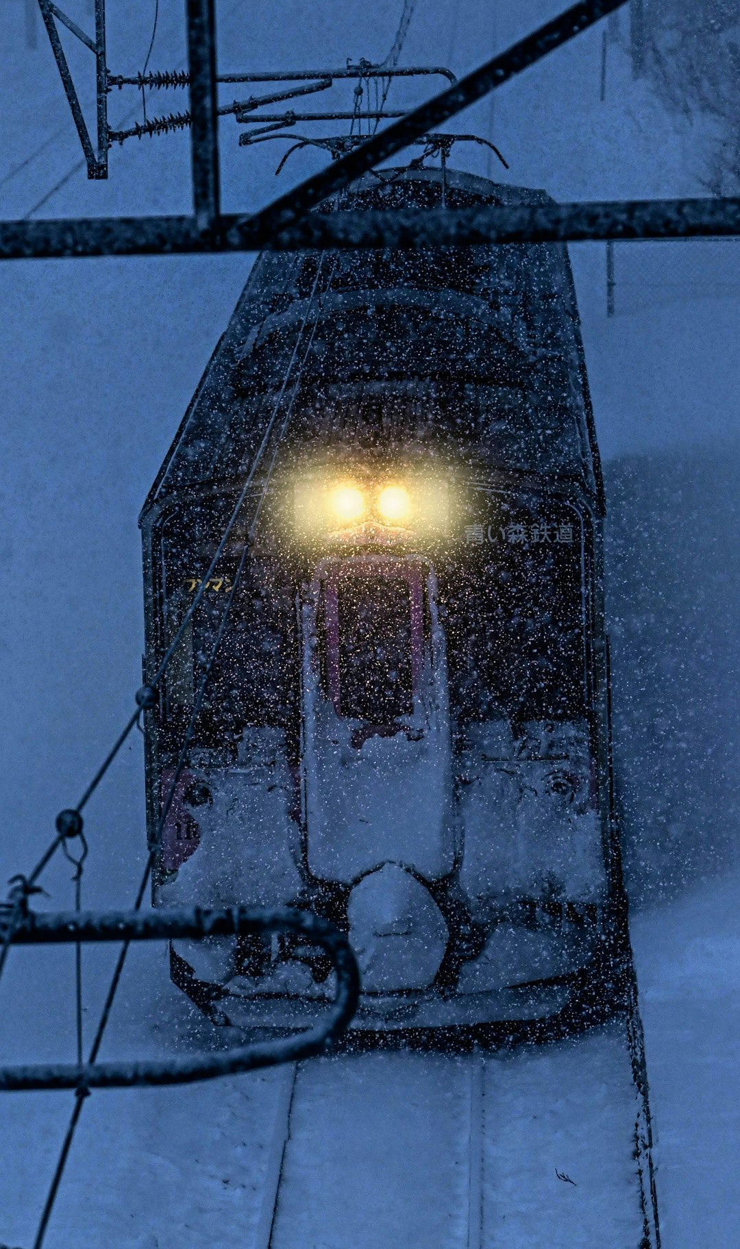 night exterior wall with a streetlight in snowfall