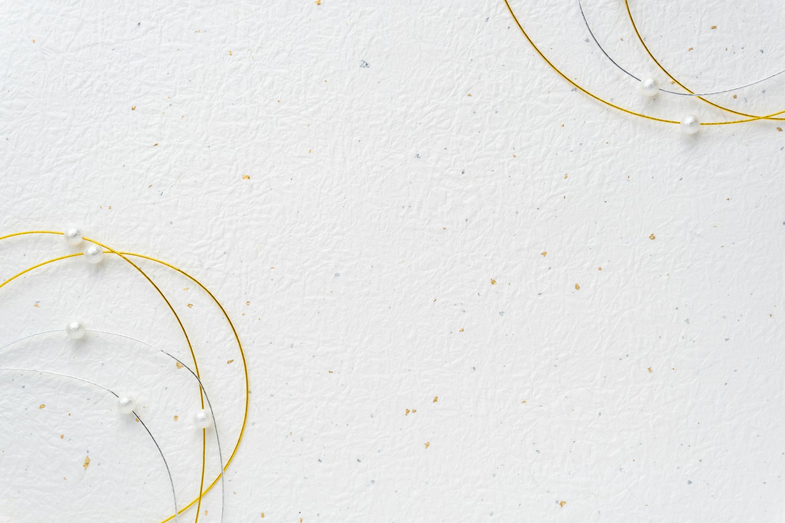Boucles d'oreilles en or disposées sur un fond blanc
