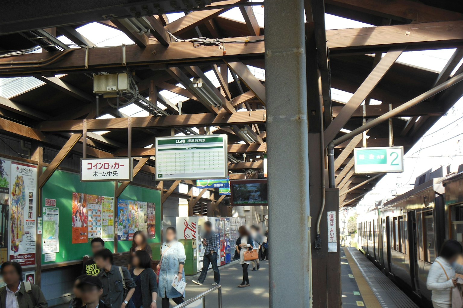 Crowded train station platform with wooden roof structure
