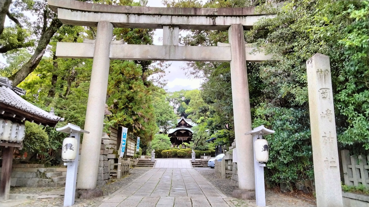 Ingresso di un santuario con un torii circondato da vegetazione