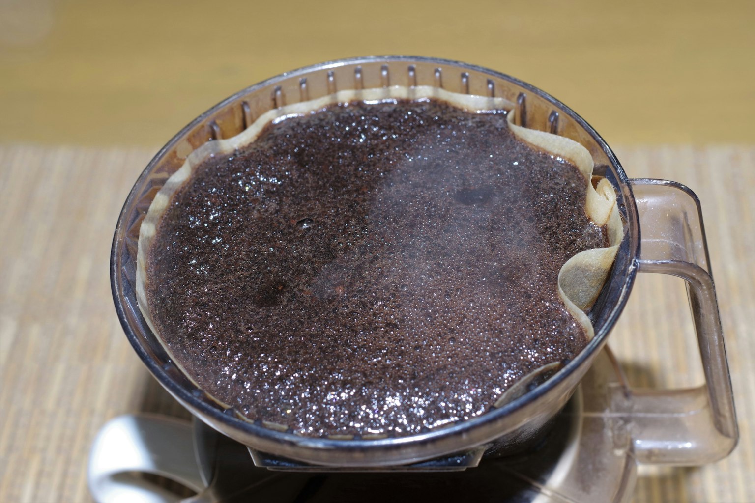 Transparent coffee filter with steaming coffee brewing inside