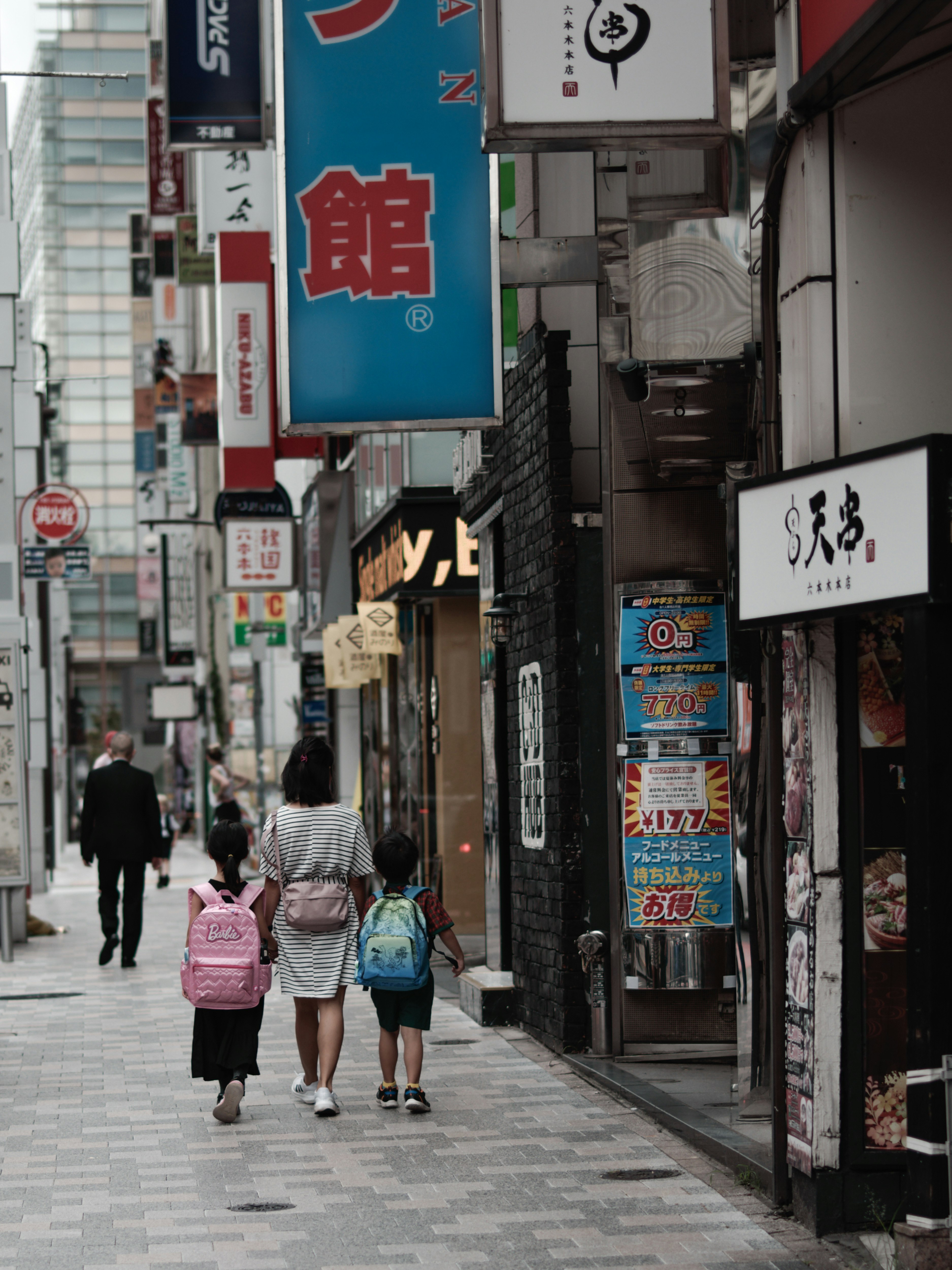 Roppongi 4-chome narrow shopping alley with storefront signs