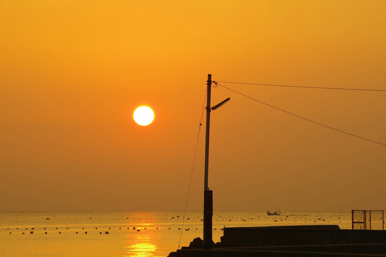 Sunset over the sea with calm water surface