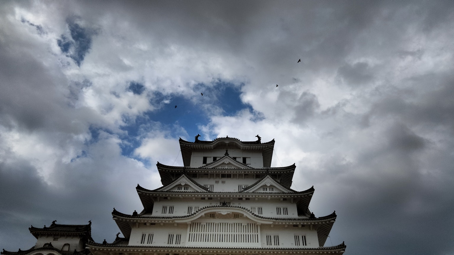 View of a white castle under a dramatic sky