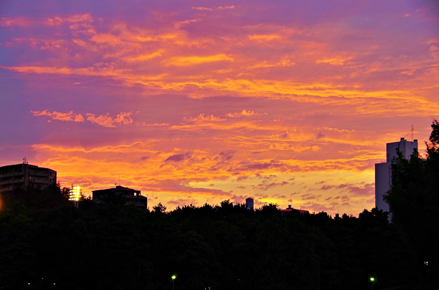 Vibrant sunset sky with silhouetted buildings