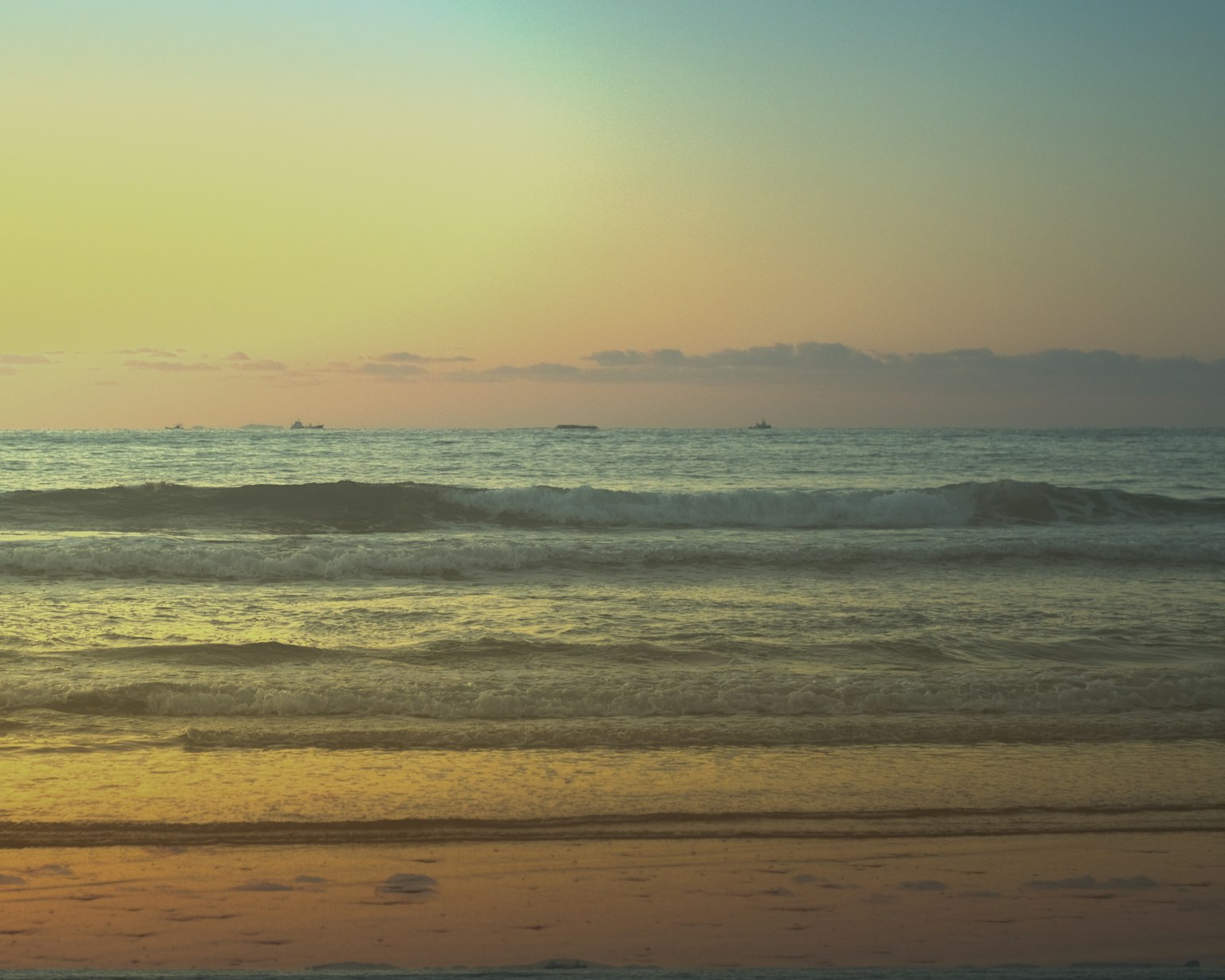 Calm ocean and sunset scene gentle waves lapping on the beach