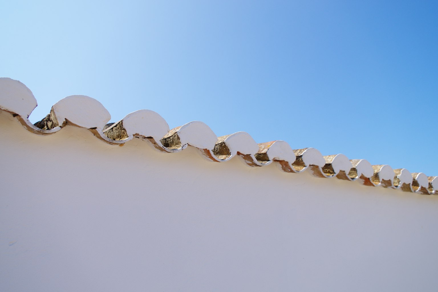 White roof edge under a clear blue sky