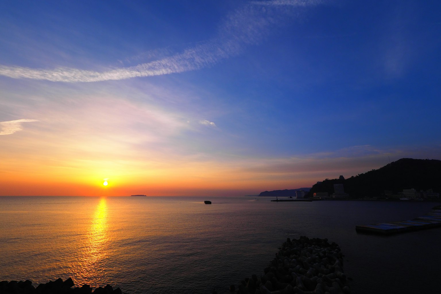 Beautiful sunset over the ocean blue sky with white clouds