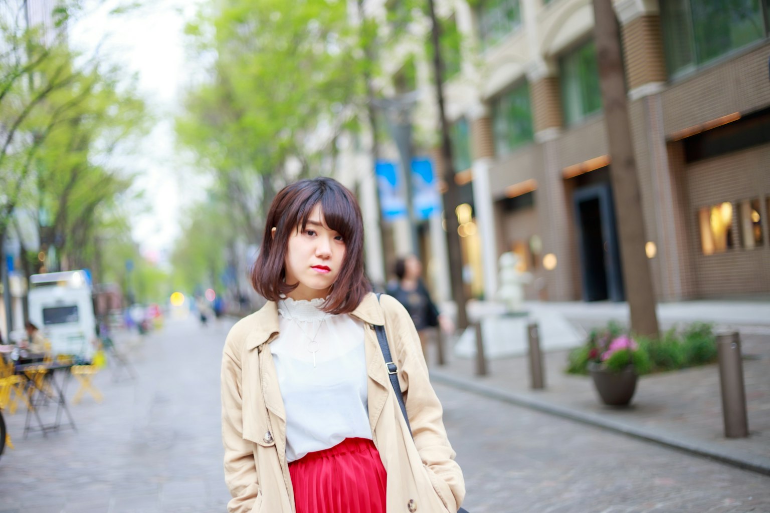 A woman in casual attire walking in an urban street