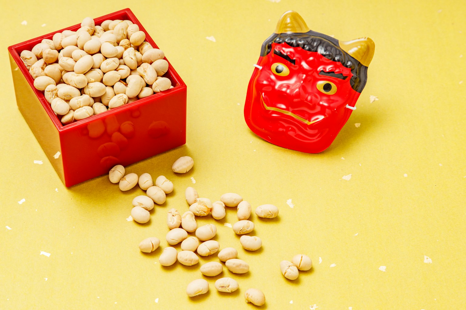 Image featuring a red box filled with soybeans and a demon mask