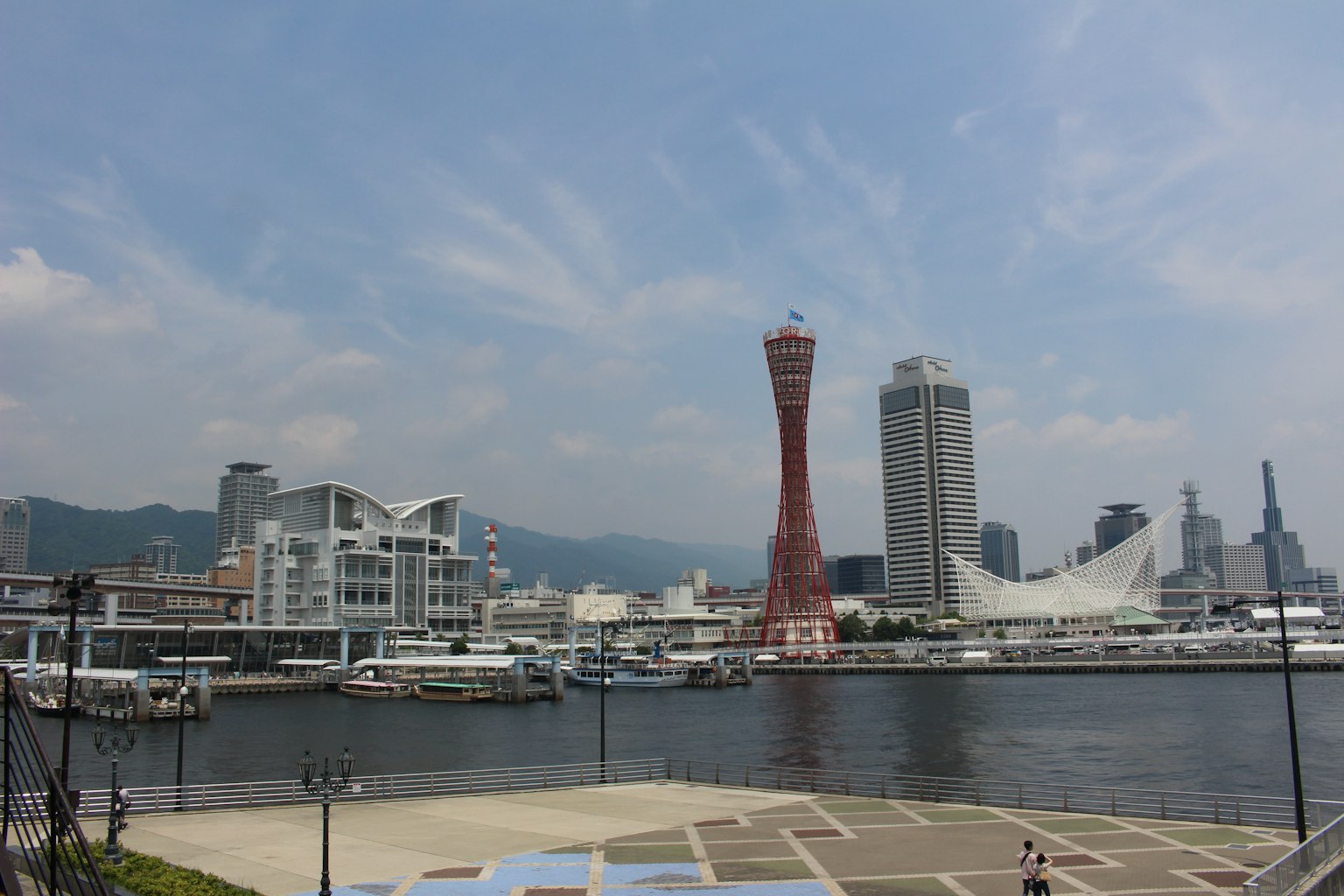 Blick auf den Hafen von Kobe mit Hochhäusern und dem Berg Maya im Hintergrund