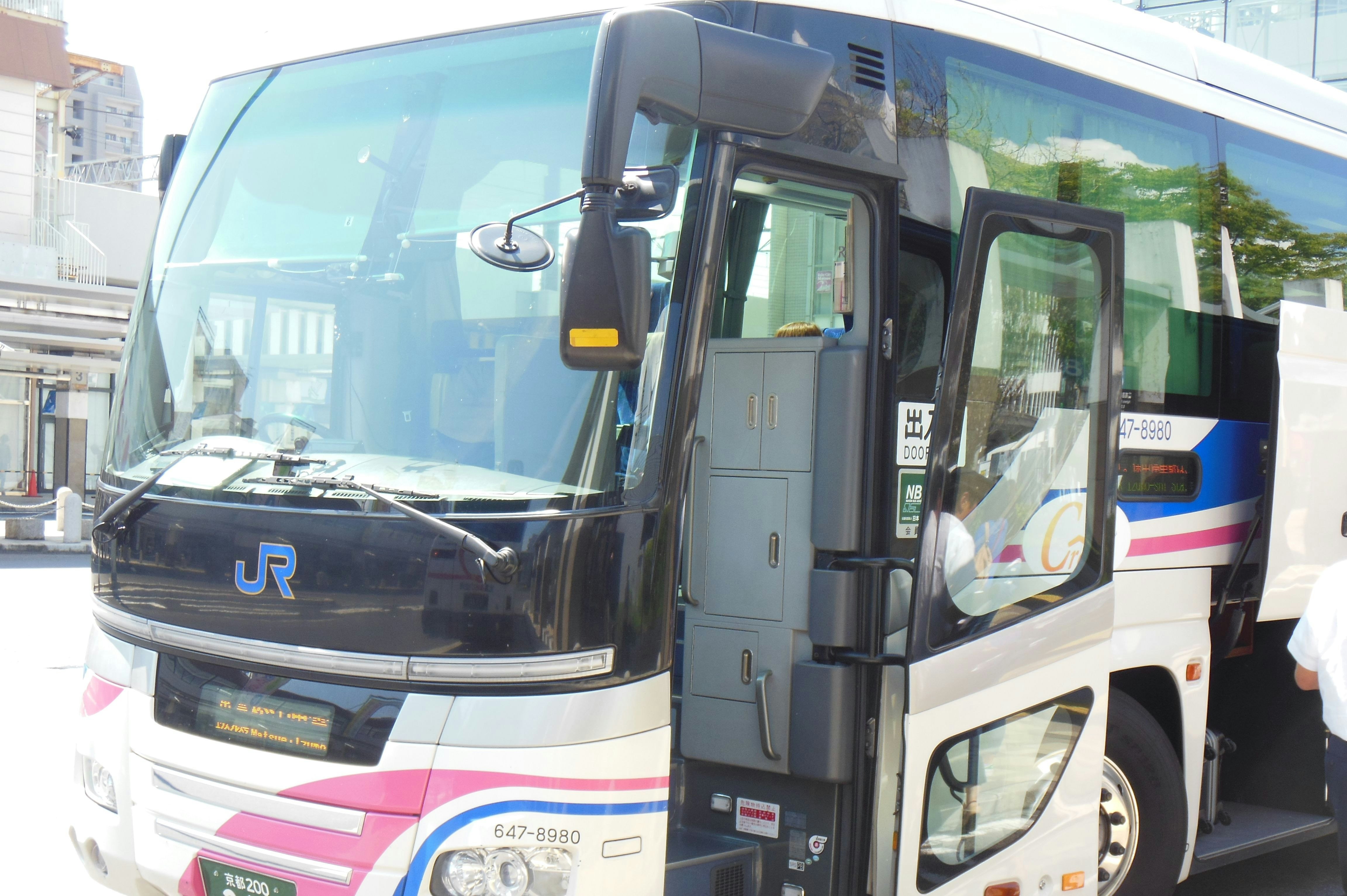 Front view of a sightseeing bus with an JR logo