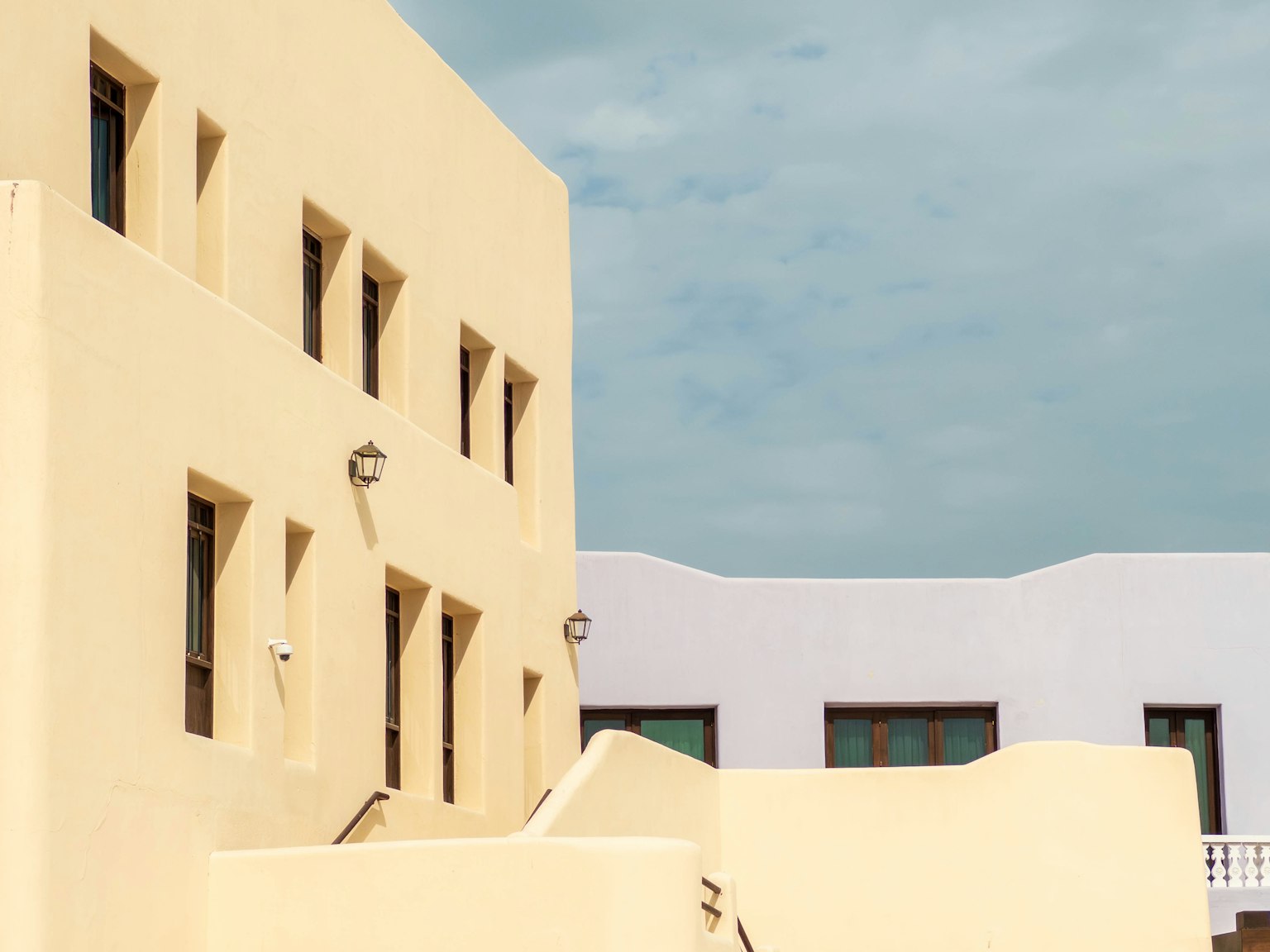 Modern architectural scene featuring light yellow and white buildings