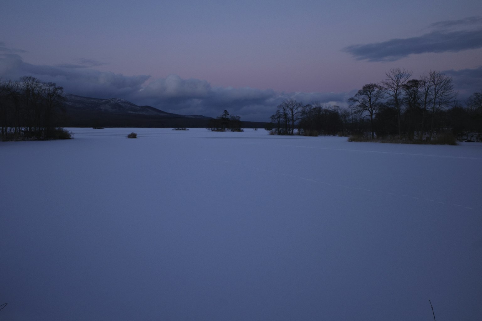 Lago coperto di neve con cielo al crepuscolo