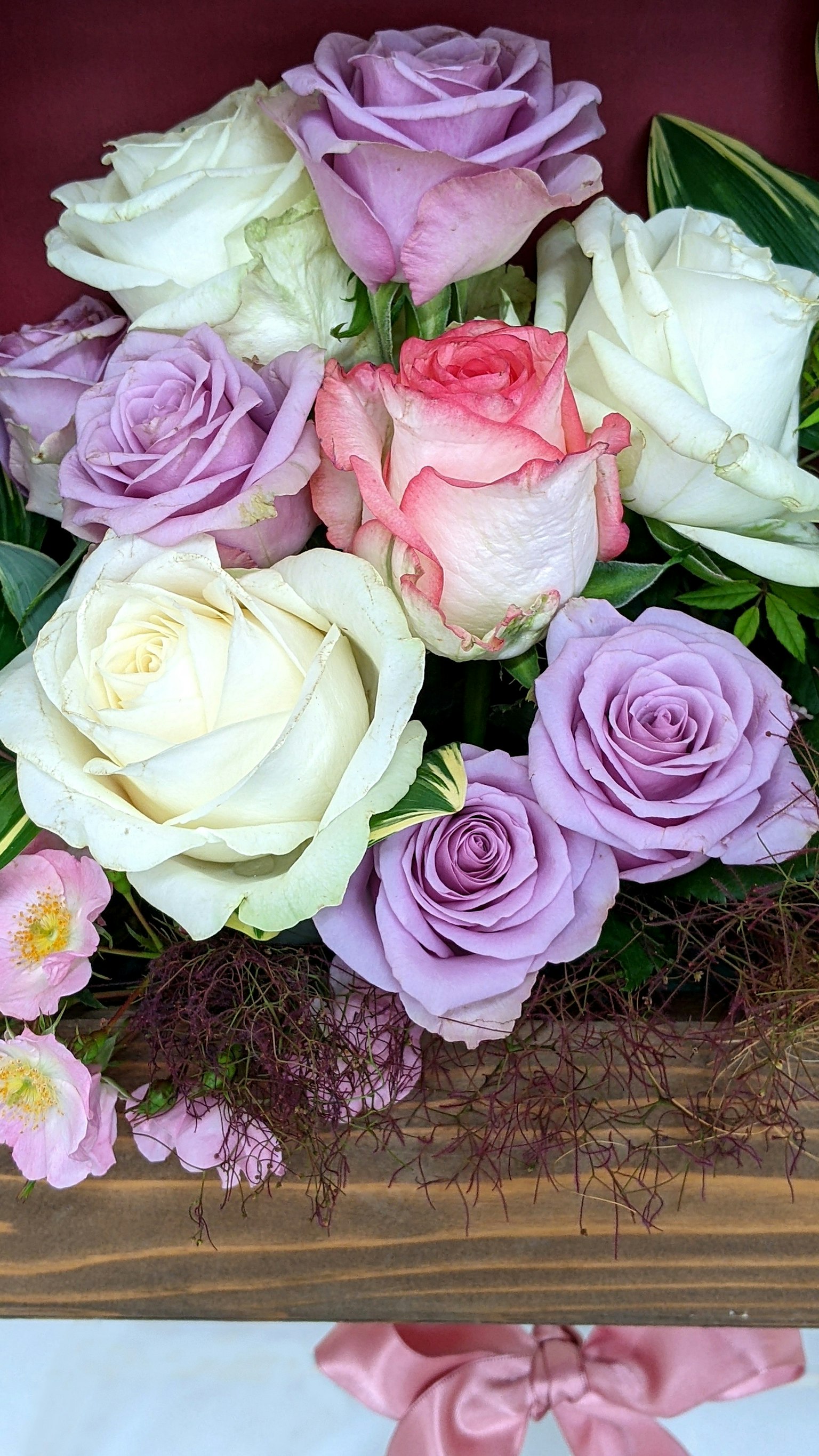 A bouquet of colorful roses featuring white and lavender roses