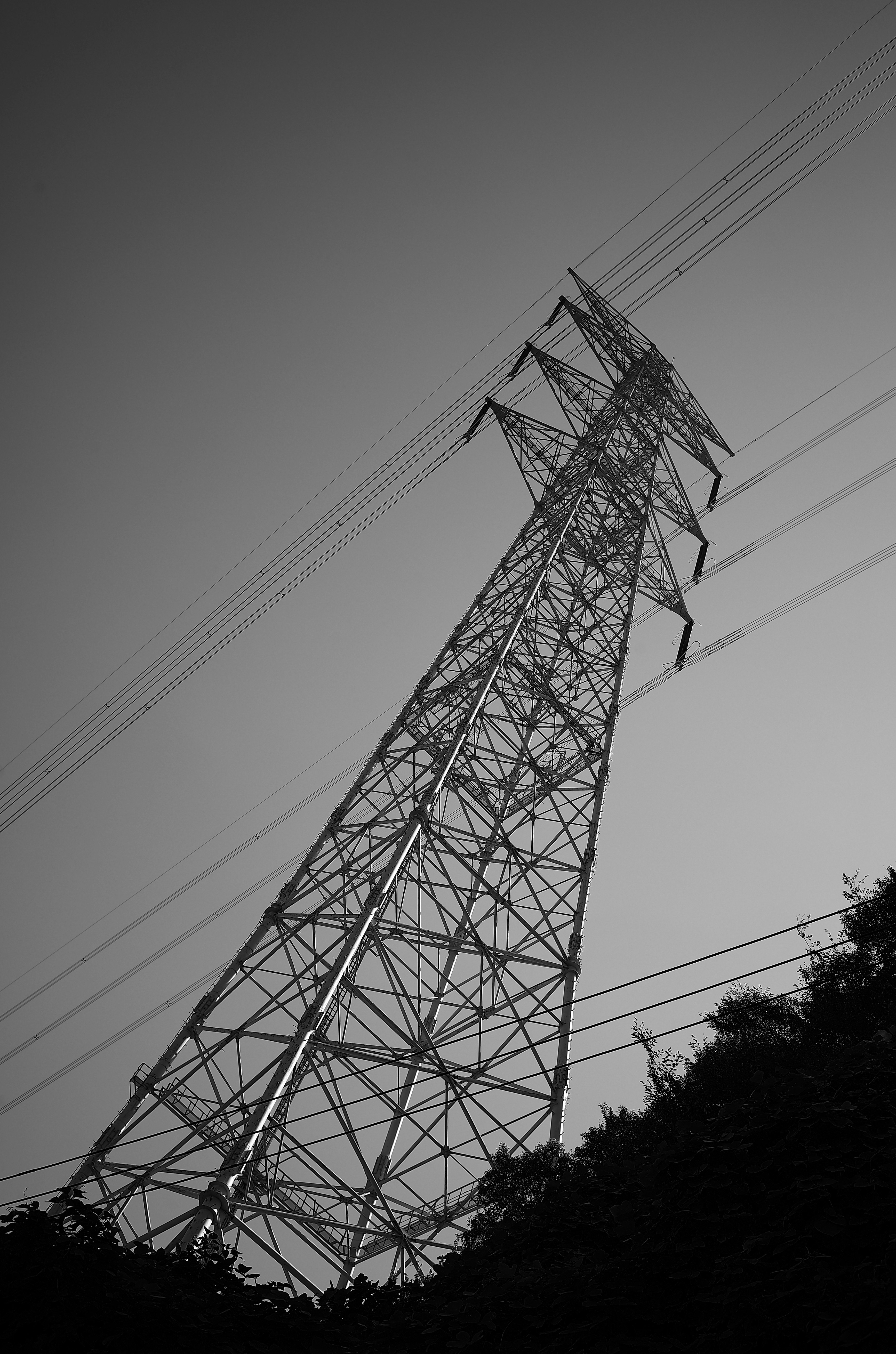 power transmission tower with overhead lines against the sky