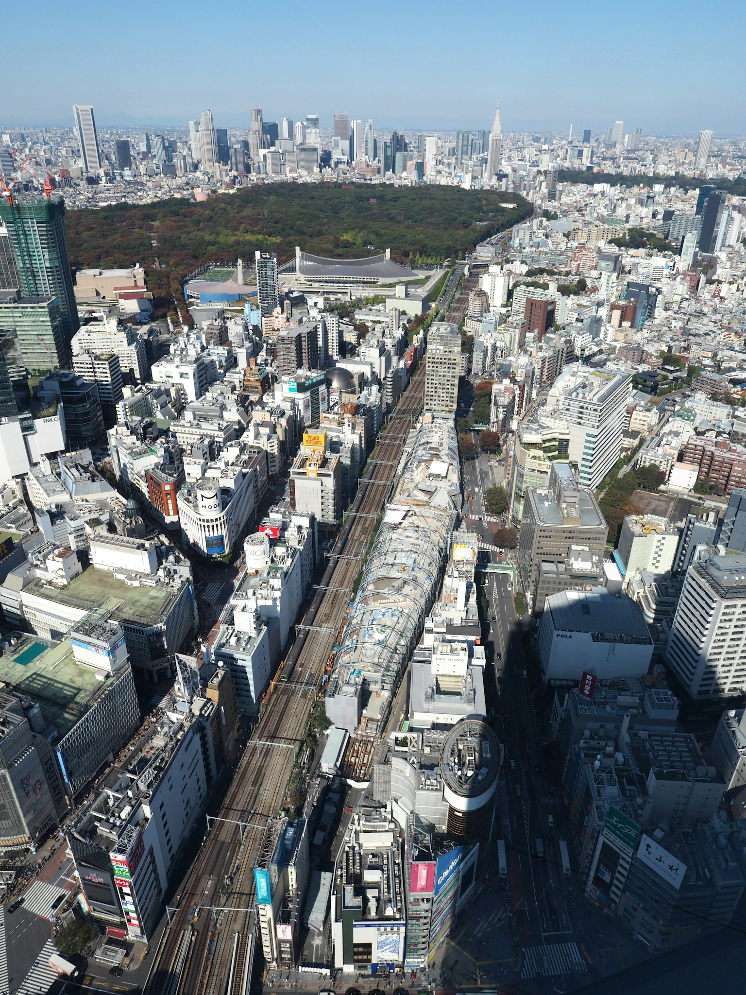 Aerial view of Tokyo featuring skyscrapers and a park