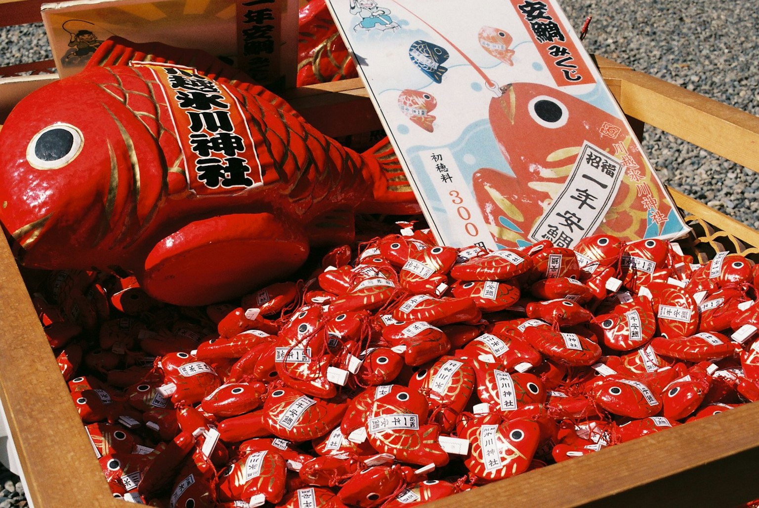 Image of a box filled with red fish-shaped charms and small red fish