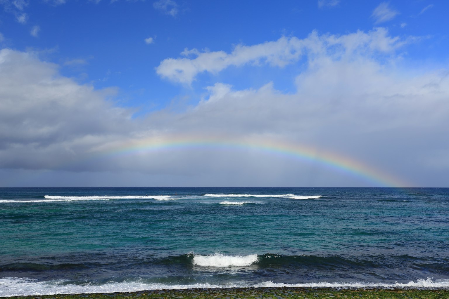 Beautiful landscape with blue ocean and a rainbow in the sky