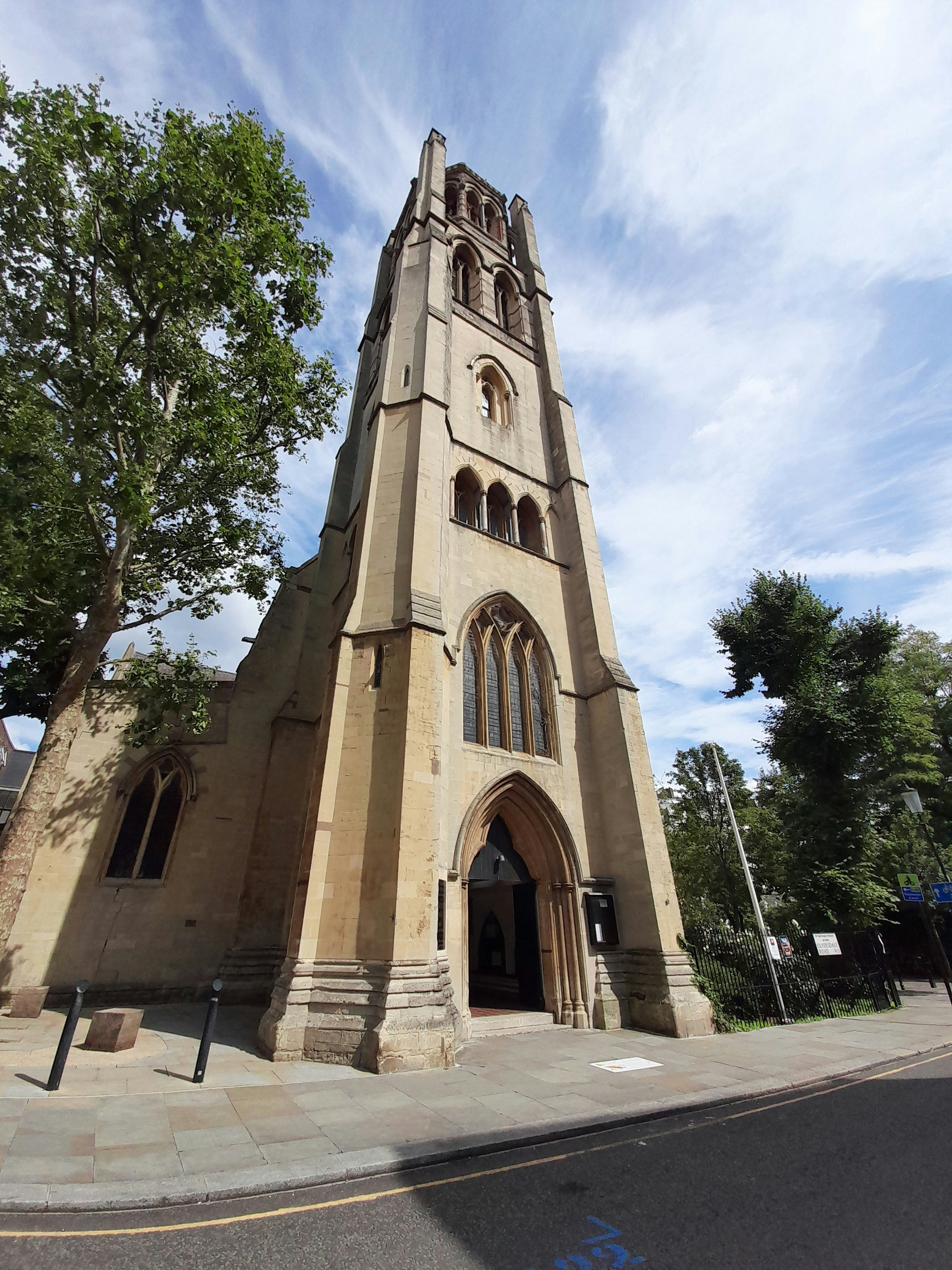 church steeple and front entrance under a blue sky