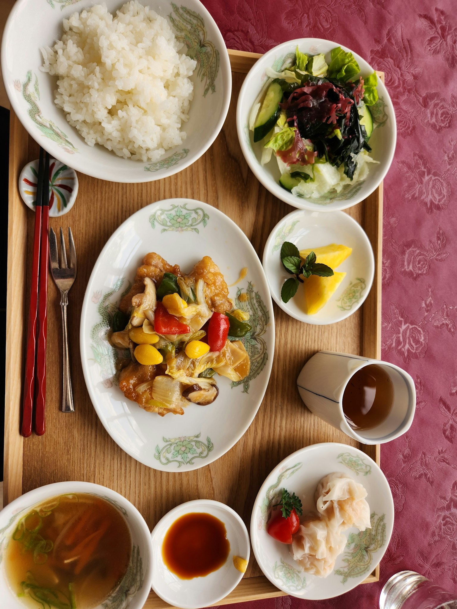 A beautifully arranged plate of Chinese cuisine featuring colorful vegetables and shrimp