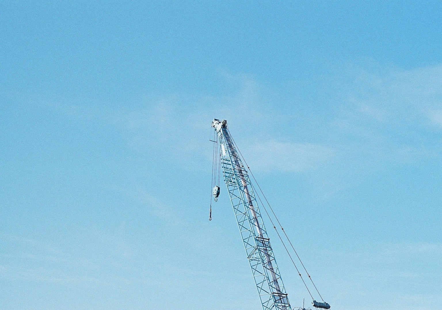 Tall crane structure under a clear blue sky