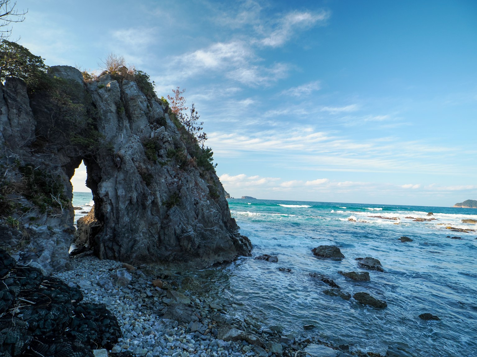Scenic view of ocean with rocky arch formation