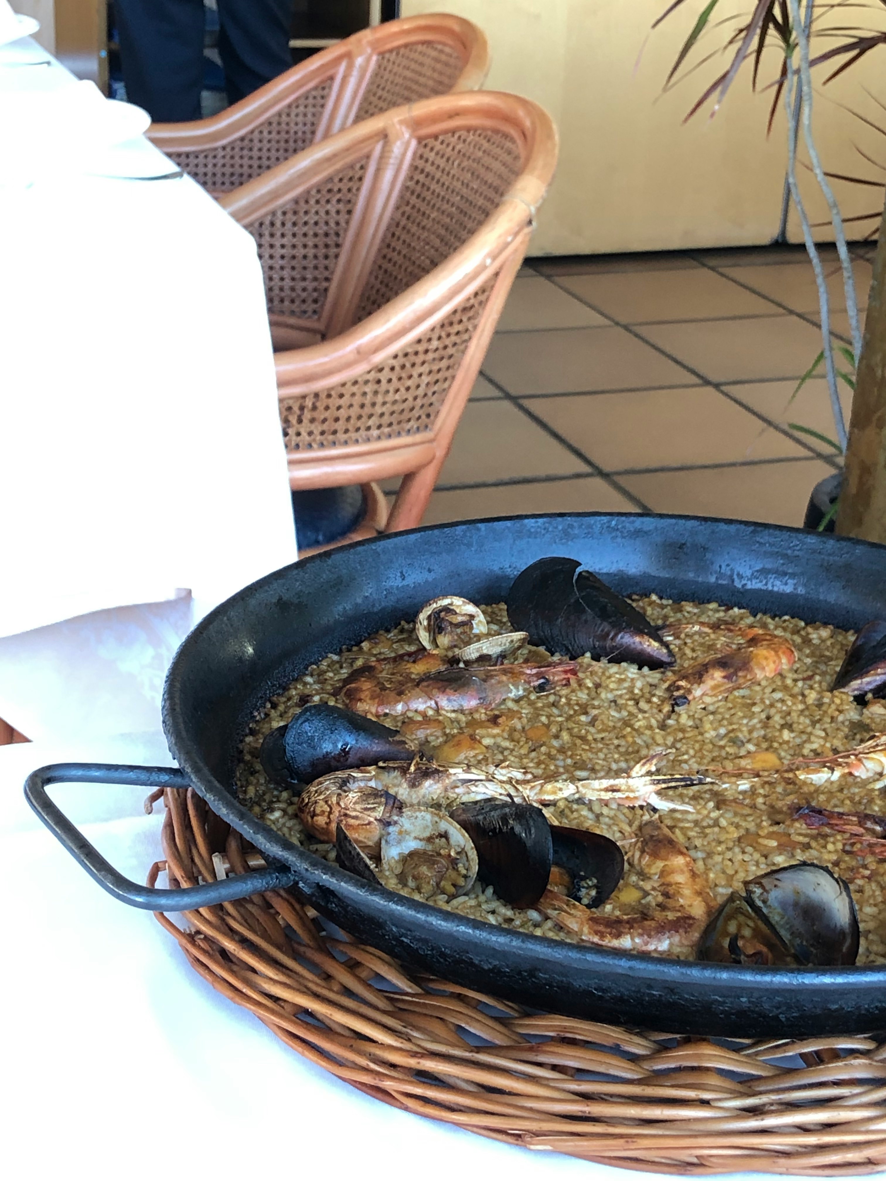 Mussels and paella-style rice cooking in a skillet