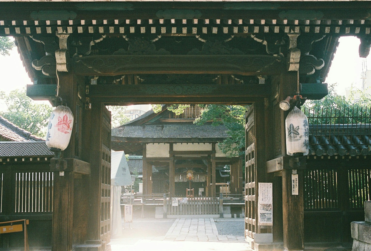 Traditional Japanese wooden gate leading to a serene temple courtyard