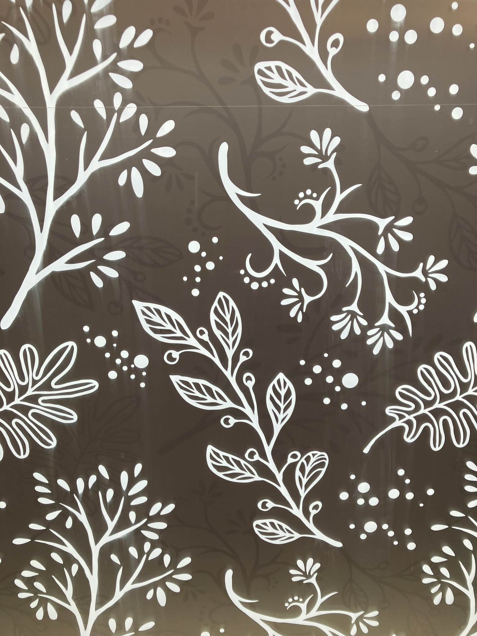 White botanical patterns on a brown background