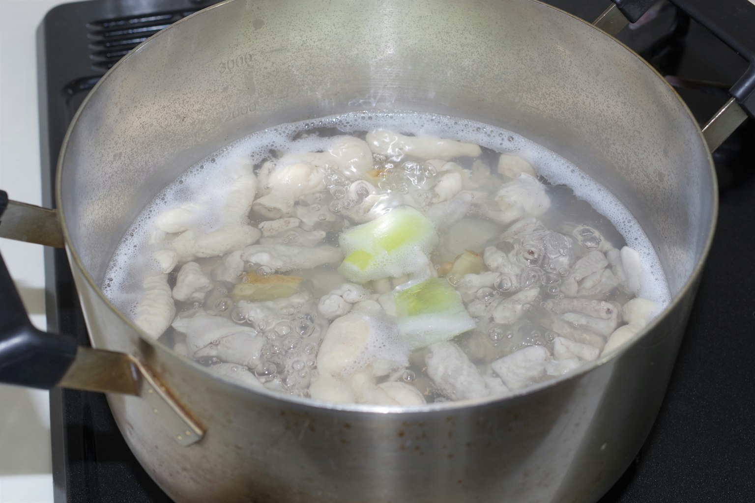 Cooking meat and vegetables in a pot of broth
