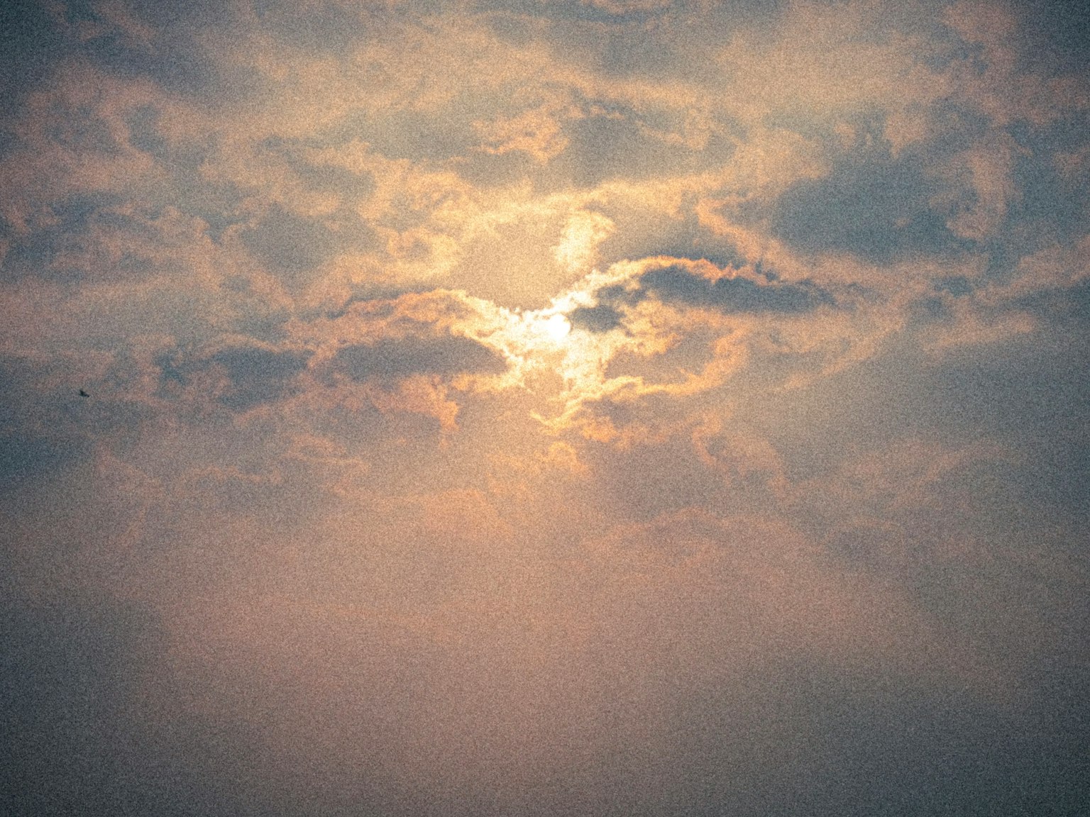 Beautiful sky with sunlight breaking through clouds