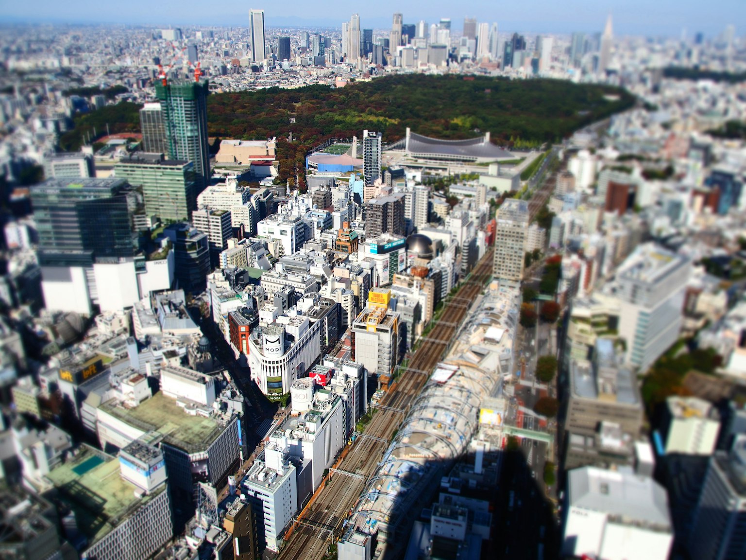 Aerial view of Tokyo cityscape featuring skyscrapers and a green park