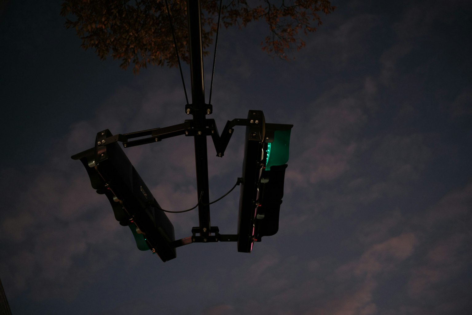 Semaforo verde visto dal basso contro un cielo notturno