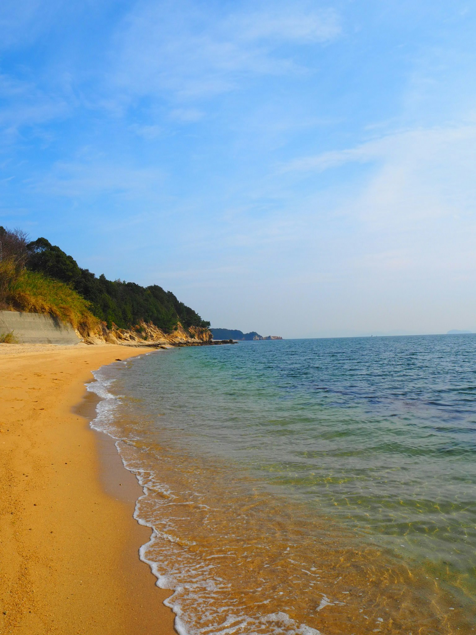 Scenic beach view with blue sky and calm sea