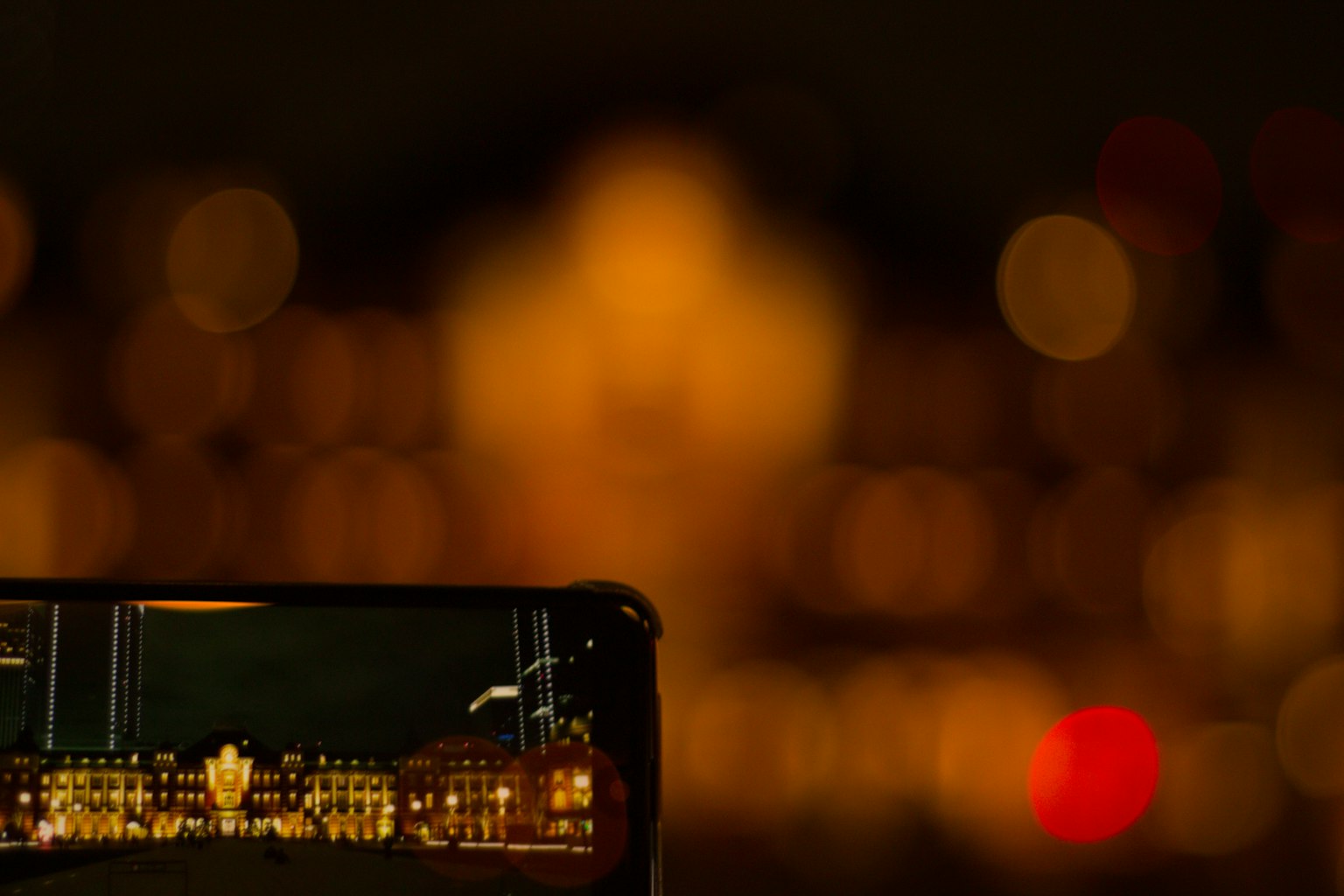 Smartphone screen displaying a brightly lit building against a dark background