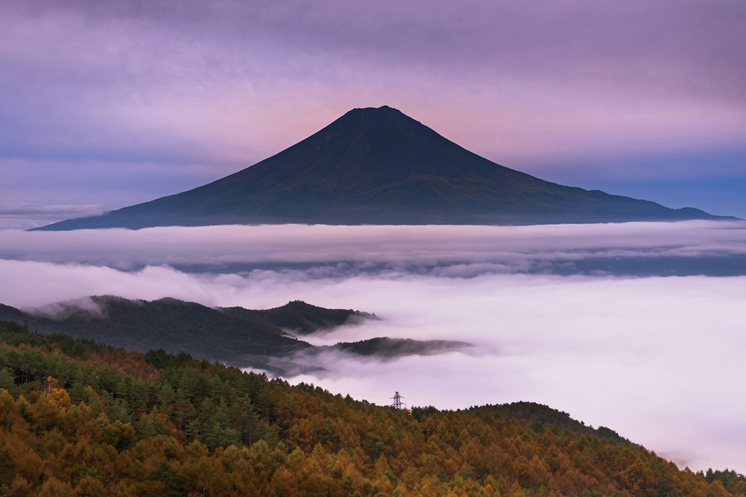 Mount Fuji towering above clouds in a stunning landscape