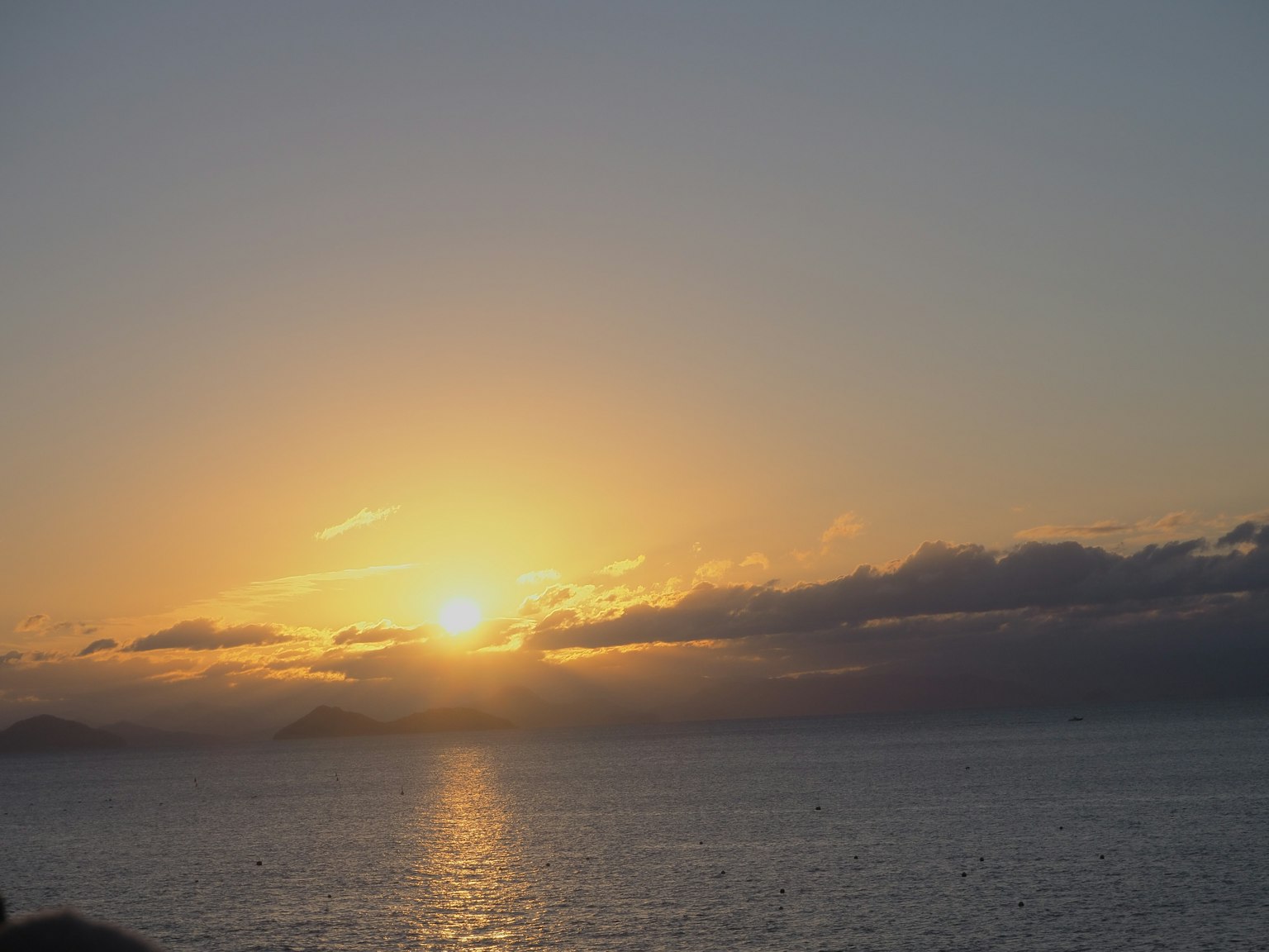 Tramonto sul mare con nuvole e riflessi