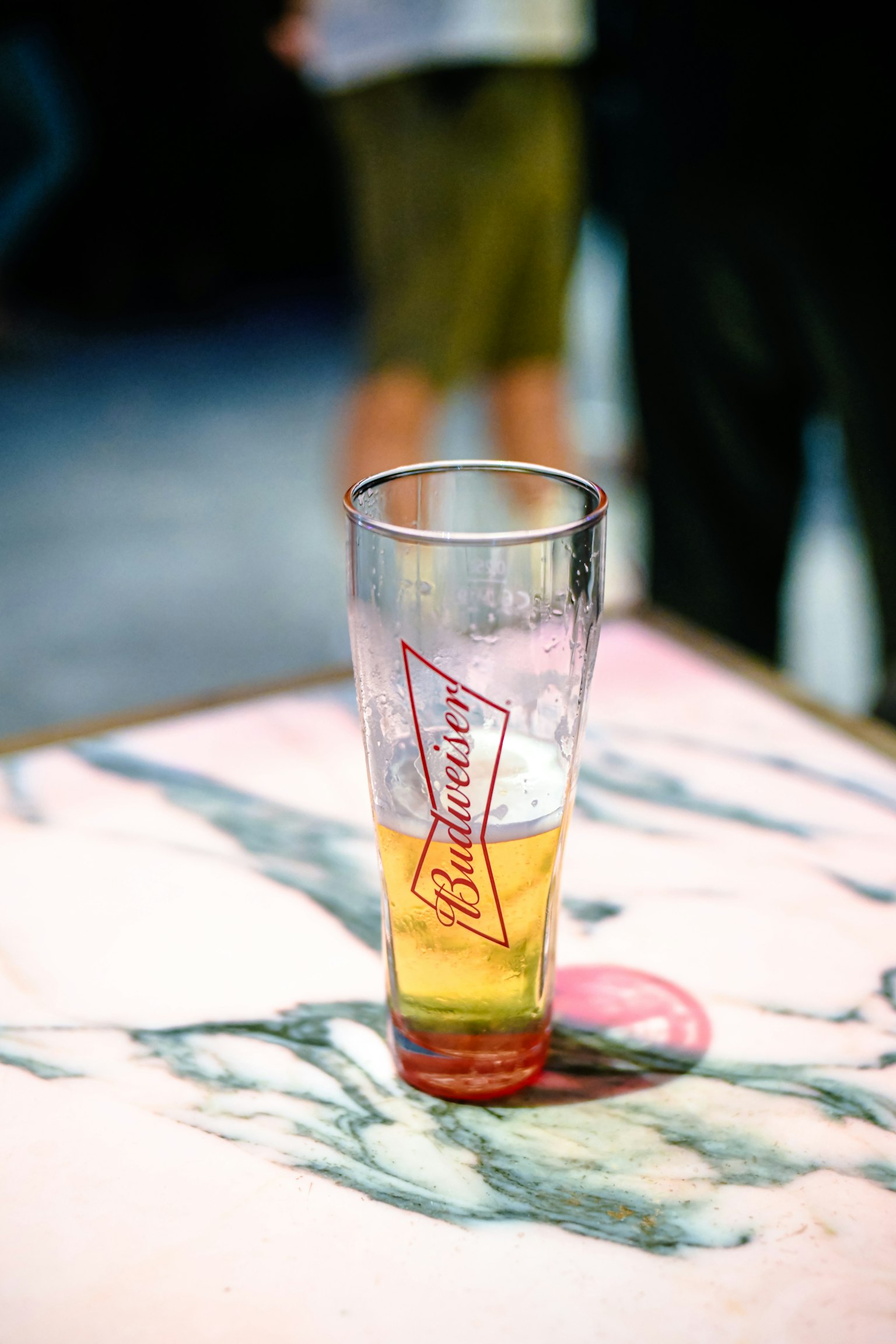 A glass of beer on a table with a colorful surface